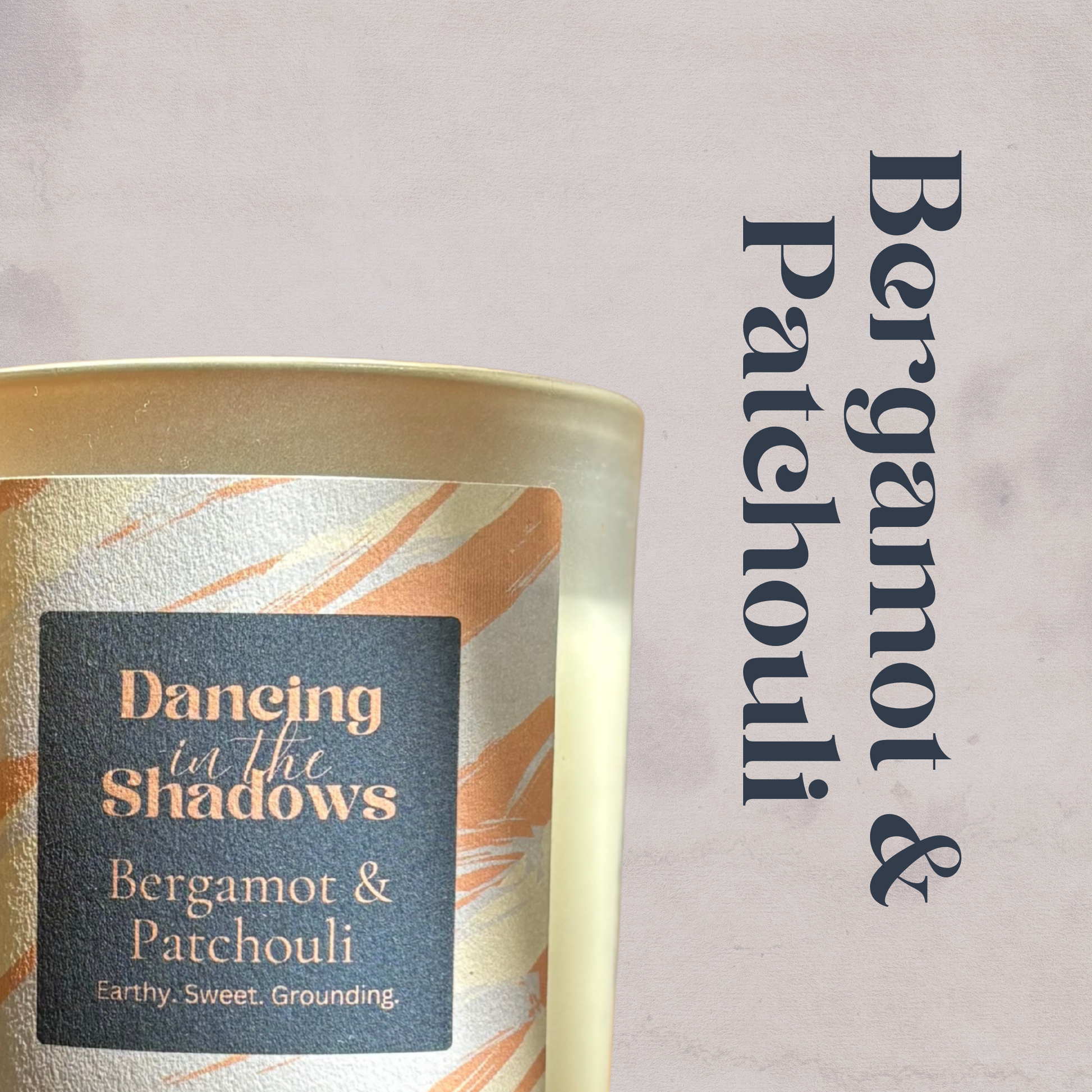Candle with 'Bergamot & Patchouli' label on a light background
