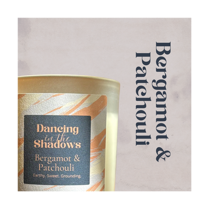 Candle with 'Bergamot & Patchouli' label on a light background