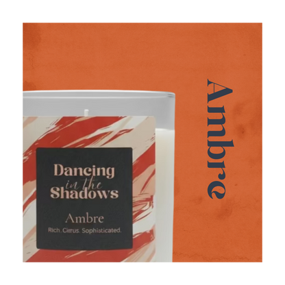 Image of an Ambre candle with its product colour in the background and name next to it.