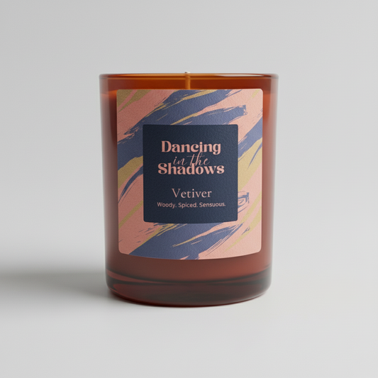 Candle with a colorful label on a light gray background